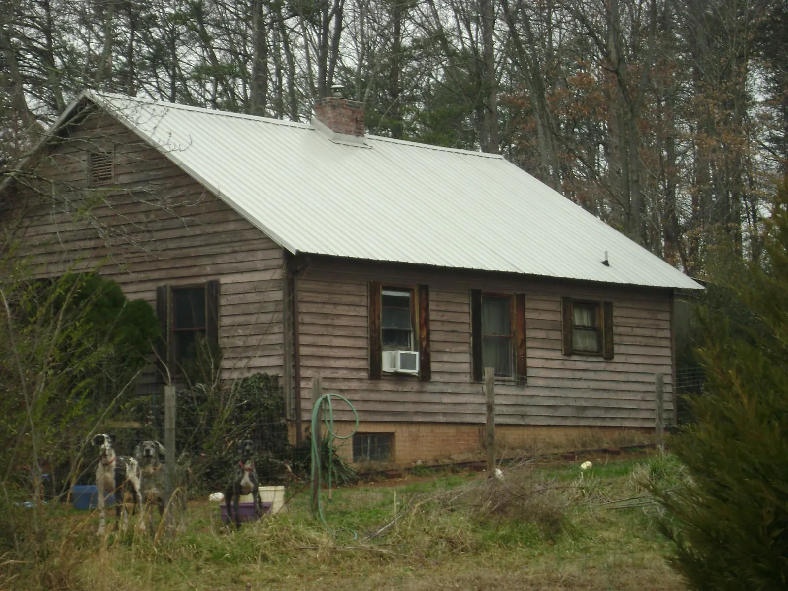 White metal roof on an old wood sided farmhouse, from a Metal Roof Installation job in New Derry
